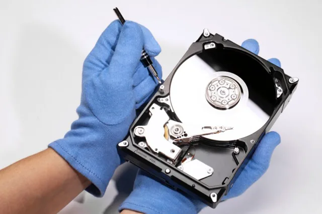Data recovery technician working on hard drive