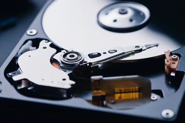 Open hard drive showing internal platters and read/write heads